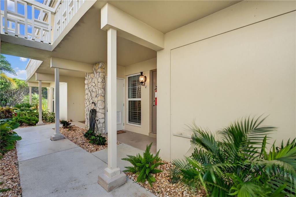1215 Edington Place, Unit A2 Marco Island, FL 34145 - Photo 29 of 29 front view of a house with potted plants