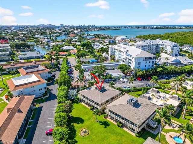 an aerial view of a house with a garden and lake view