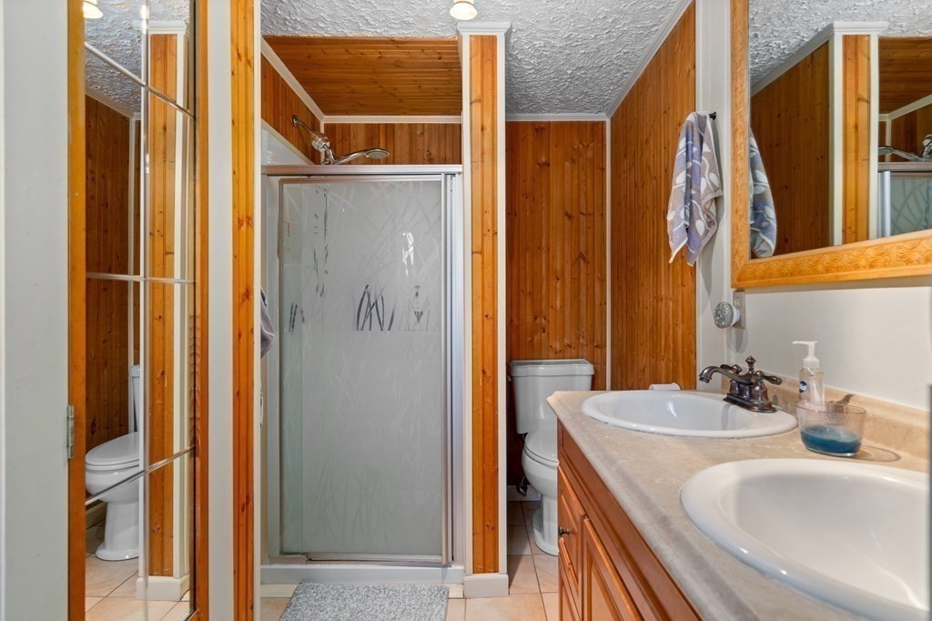 71 NW Road Westhampton, MA 01027 - Photo 27 of 41 a bathroom with a granite countertop sink and a mirror