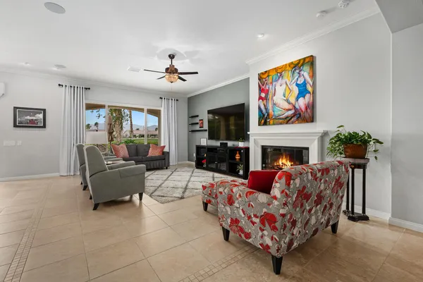 a living room with furniture fireplace and flat screen tv