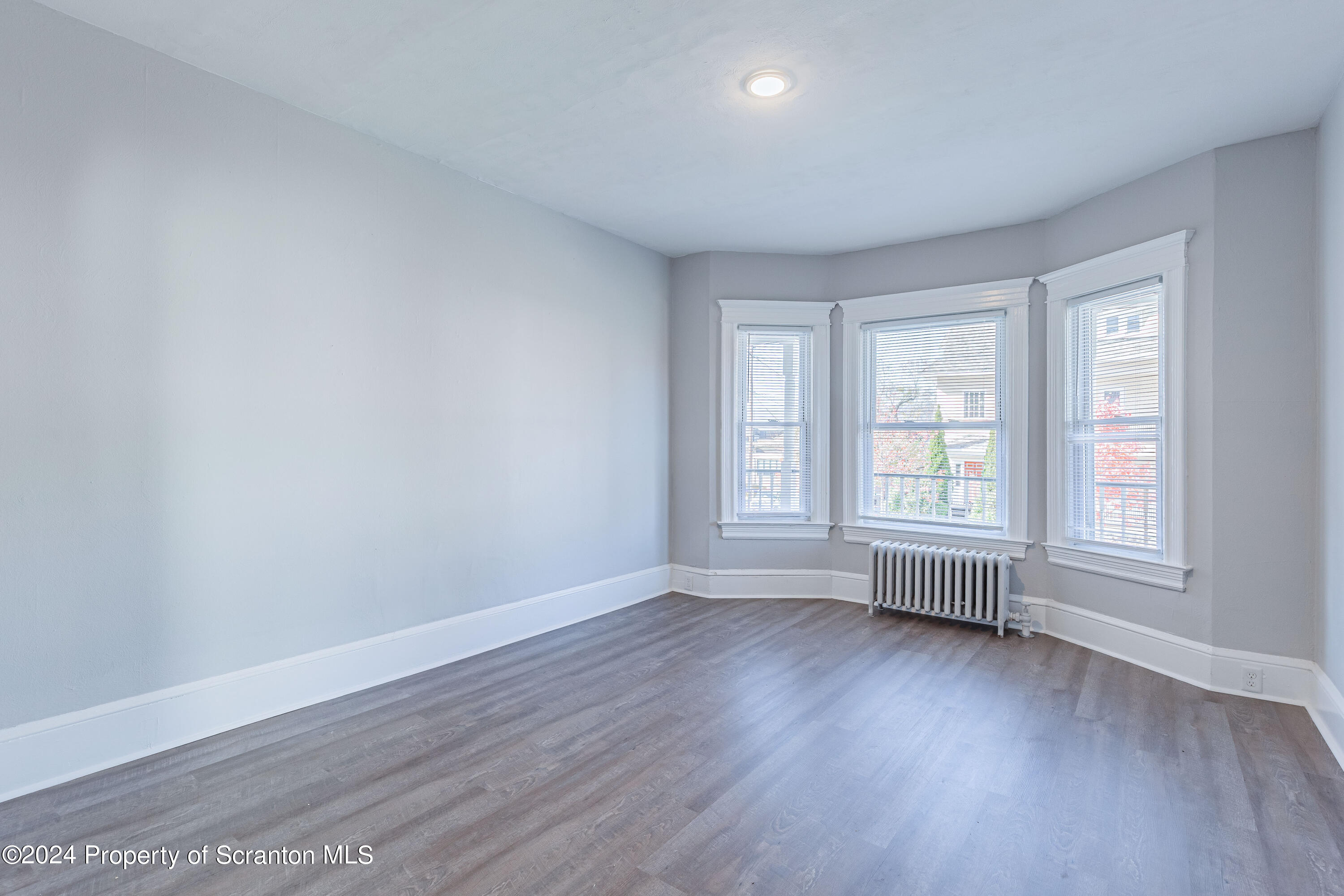 800 Quincy Avenue Scranton, PA 18510 - Photo 14 of 23 an empty room with wooden floor and windows
