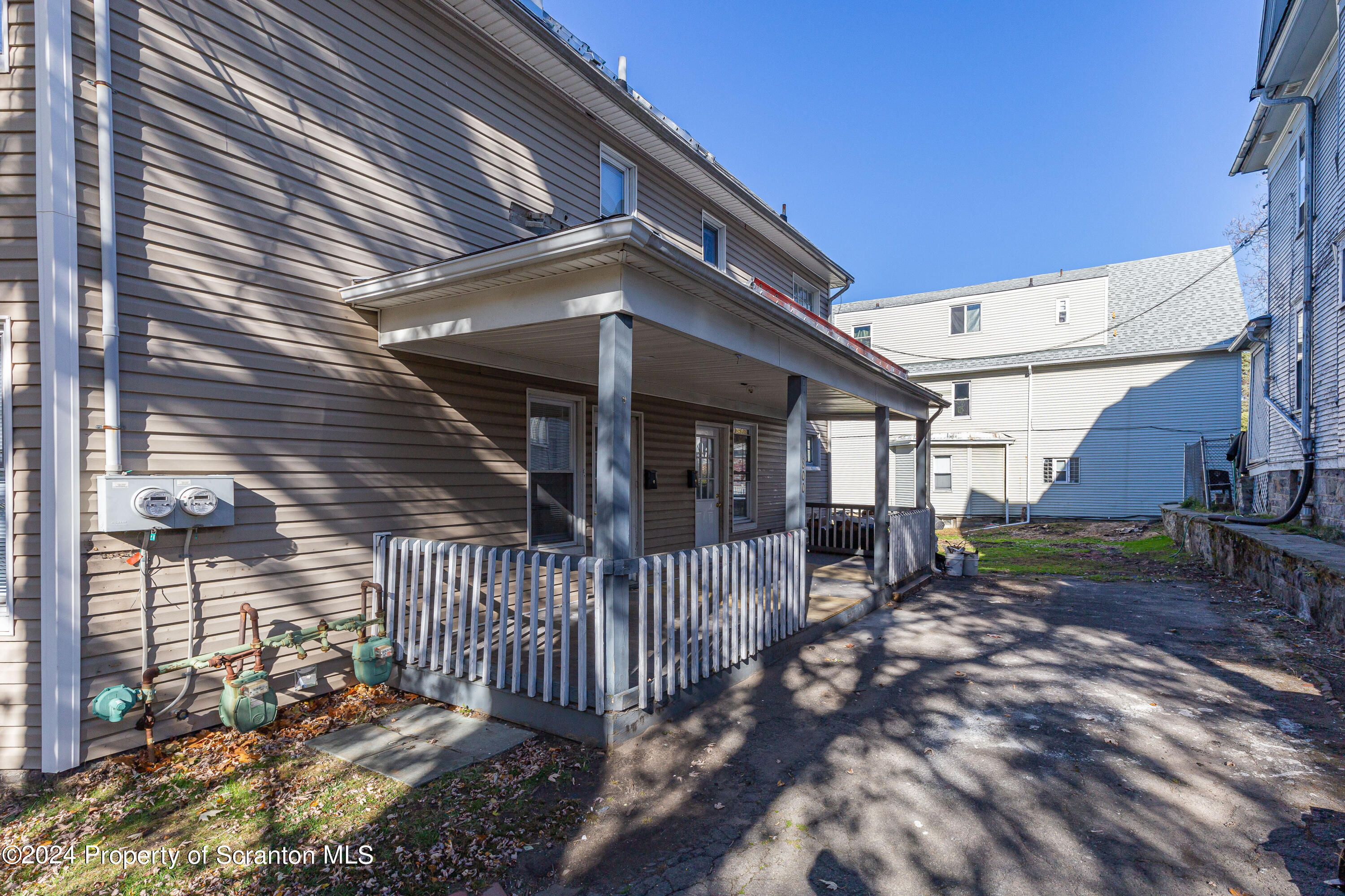 800 Quincy Avenue Scranton, PA 18510 - Photo 15 of 23 a view of a house with a small yard and wooden fence
