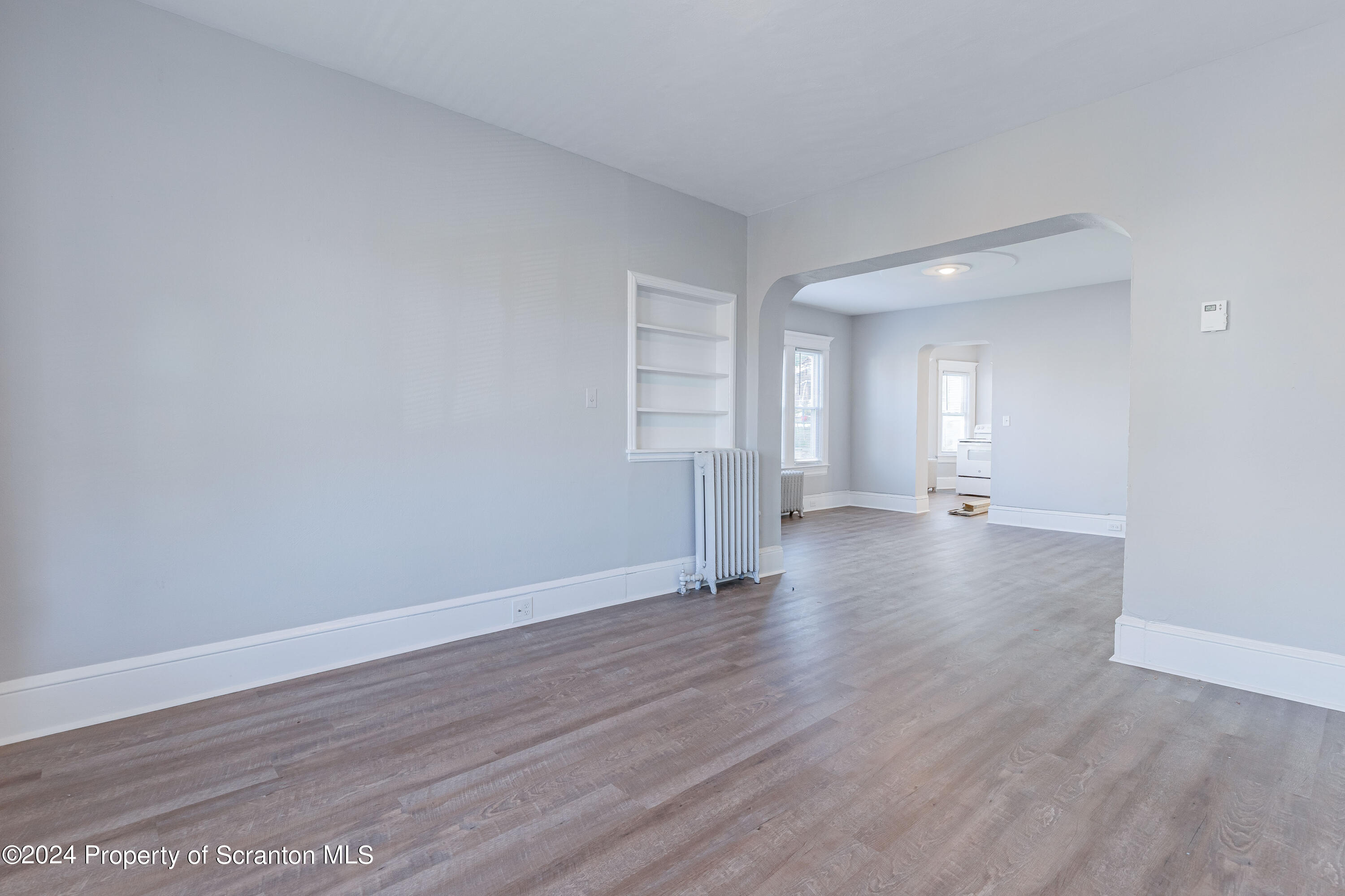 800 Quincy Avenue Scranton, PA 18510 - Photo 16 of 23 a view of an empty room with wooden floor and windows