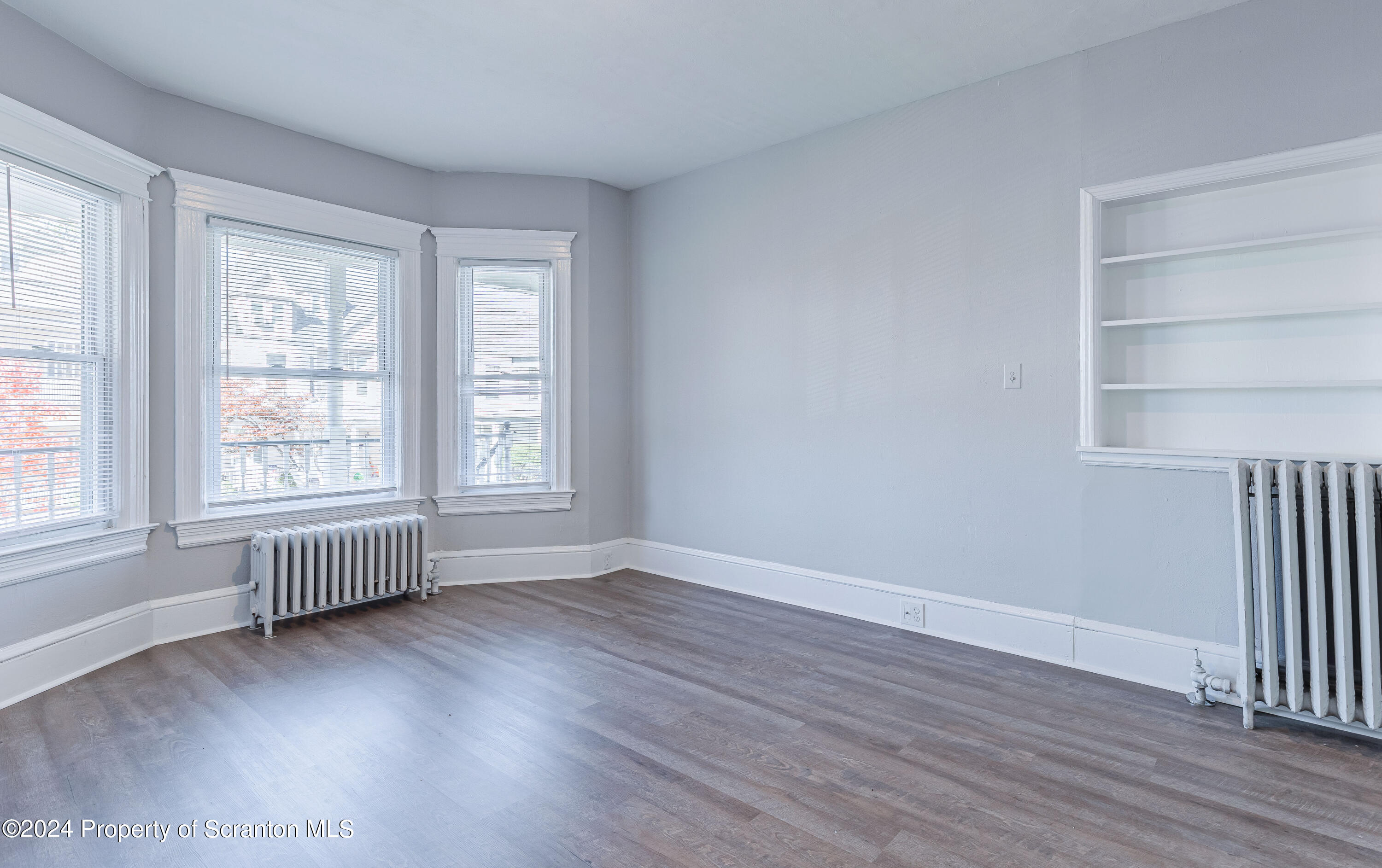 800 Quincy Avenue Scranton, PA 18510 - Photo 18 of 23 an empty room with wooden floor and windows