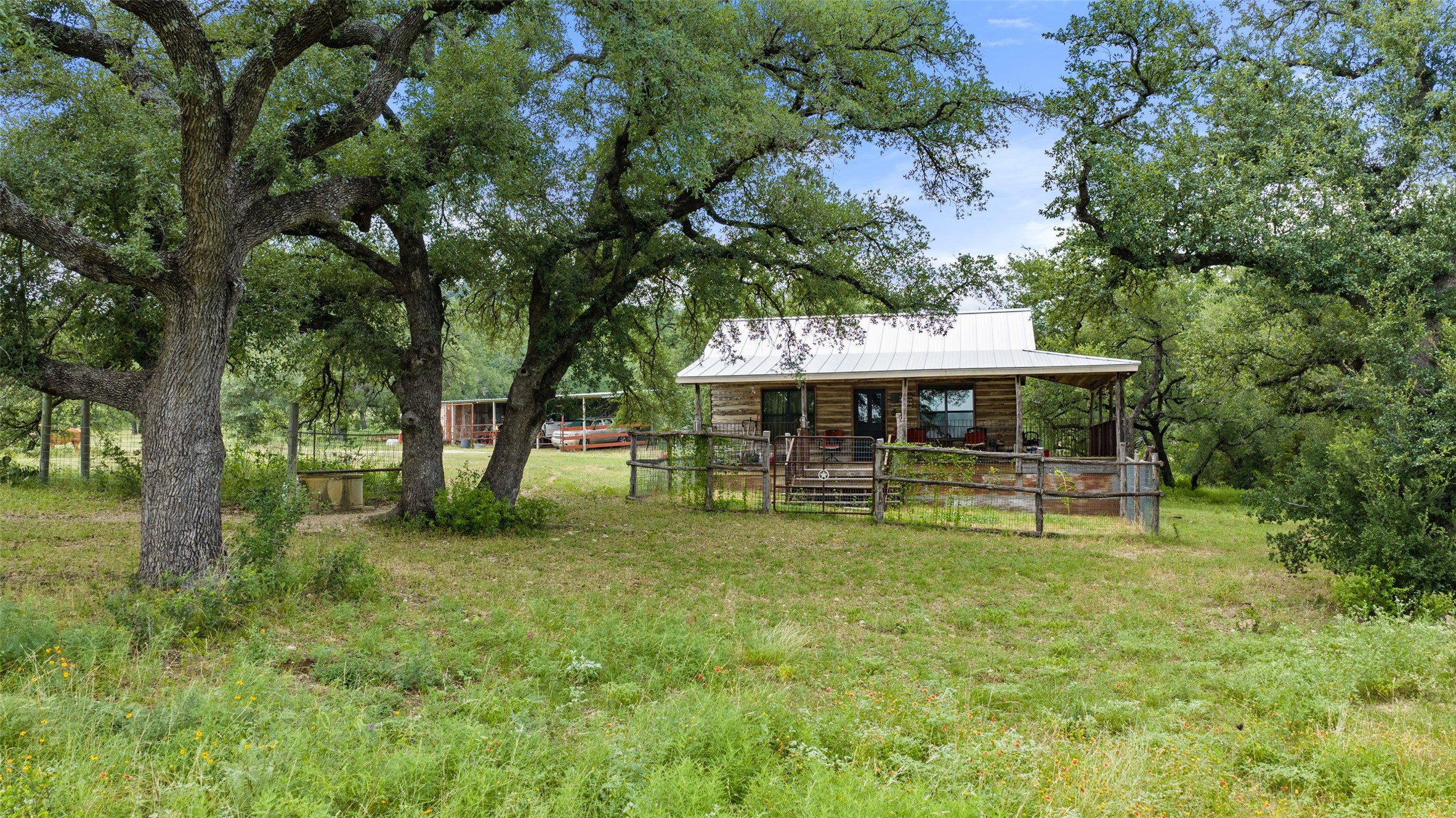 8400 Ranch Road 1431 Marble Falls, TX 78654 - Photo 24 of 30 A tranquil rural retreat, this charming cabin is nestled amongst a verdant landscape of mature trees.