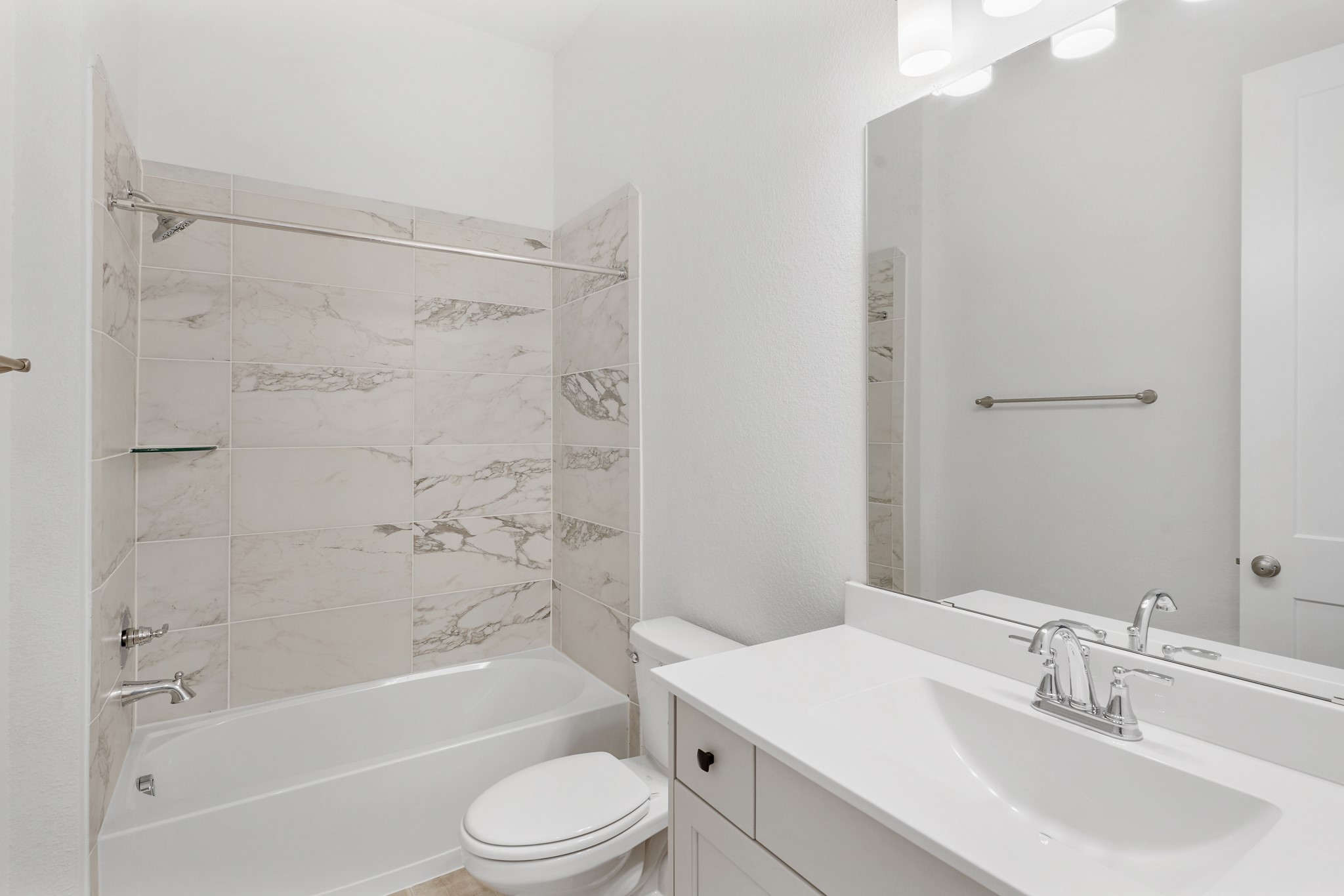 515 Tawny Rim Drive Willis, TX 77318 - Photo 11 of 22 a bathroom with a bathtub shower sink vanity mirror and toilet