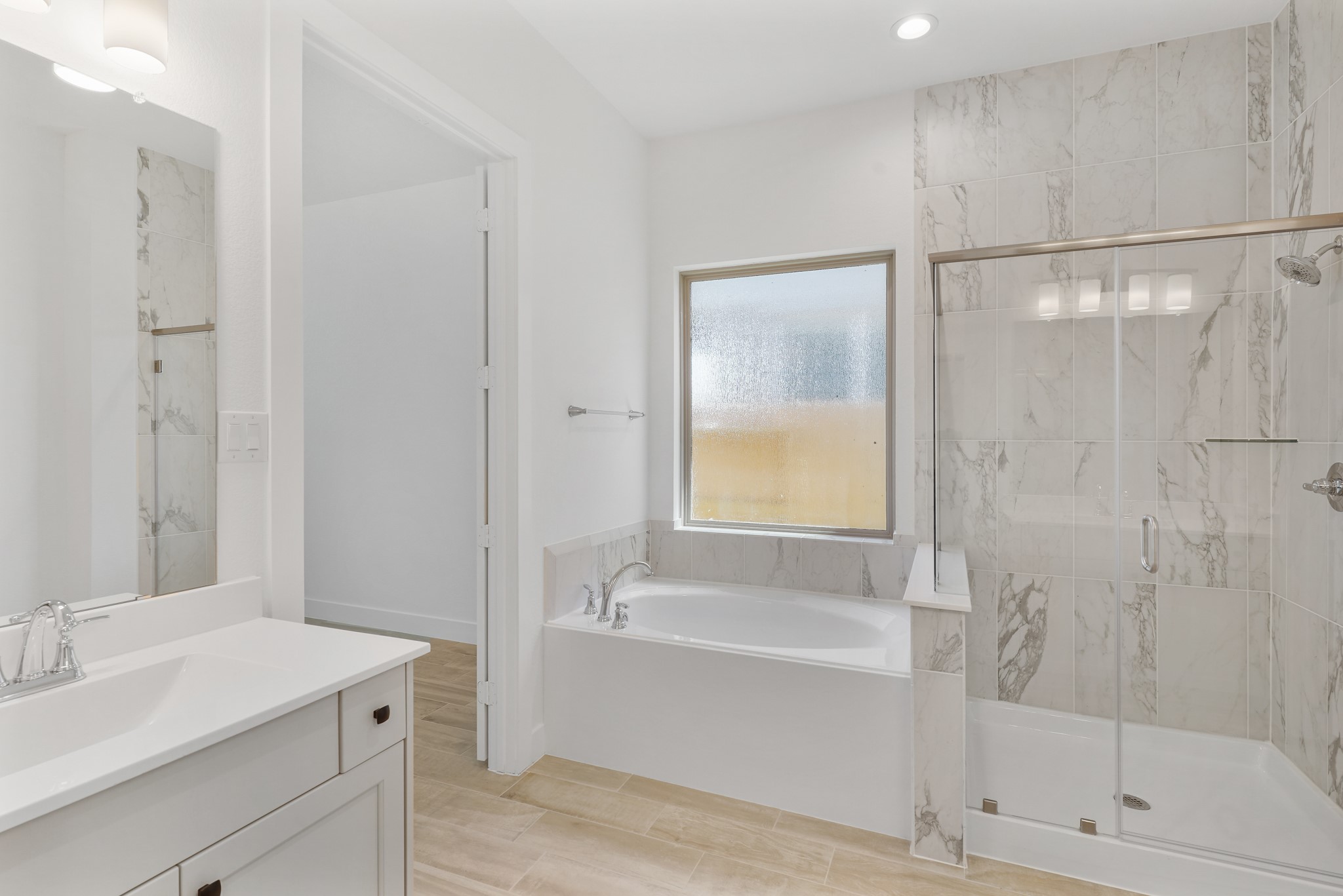 515 Tawny Rim Drive Willis, TX 77318 - Photo 5 of 22 a bathroom with a bathtub shower sink vanity and toilet