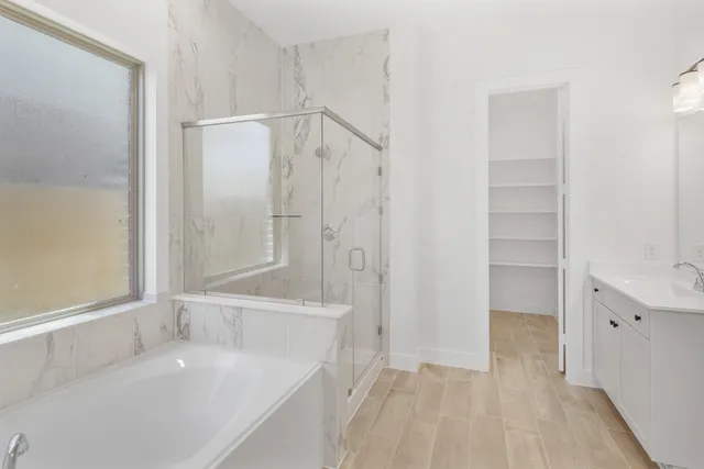 a bathroom with a bathtub and a shower