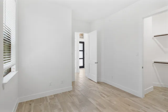 an empty room with wooden floor