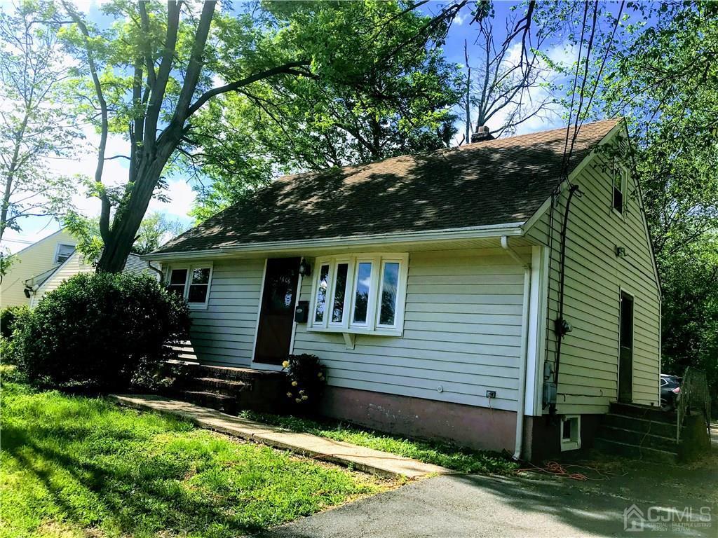 1606 Oak Tree Road Iselin, NJ 08830 - Photo 1 of 9 a front view of a house with yard and trees