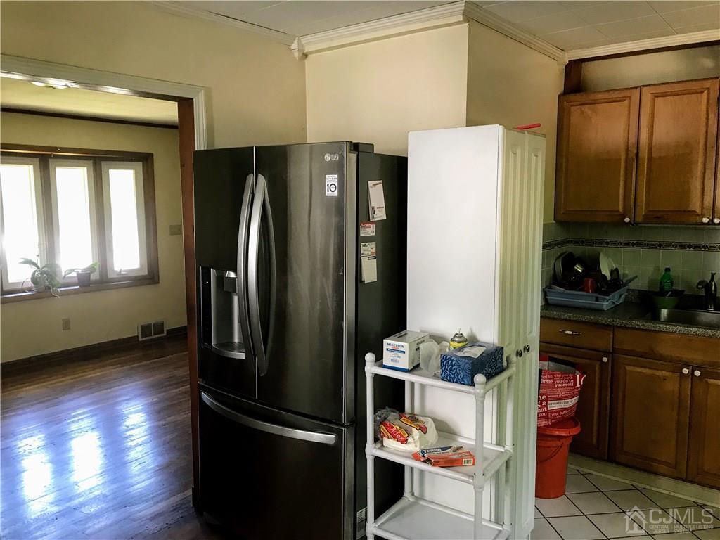 1606 Oak Tree Road Iselin, NJ 08830 - Photo 3 of 9 a kitchen with stainless steel appliances granite countertop a refrigerator and a stove