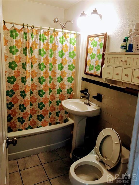 1606 Oak Tree Road Iselin, NJ 08830 - Photo 5 of 9 a bathroom with a sink toilet and shower