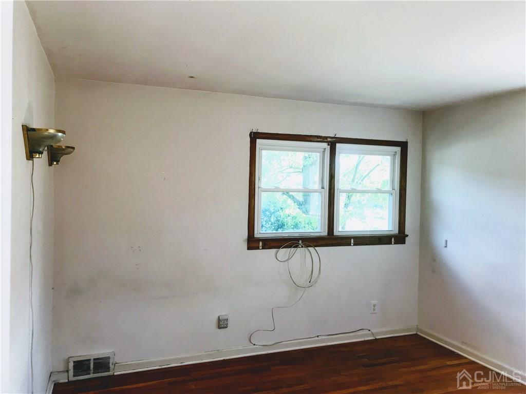 1606 Oak Tree Road Iselin, NJ 08830 - Photo 6 of 9 a room with a window and wooden floor