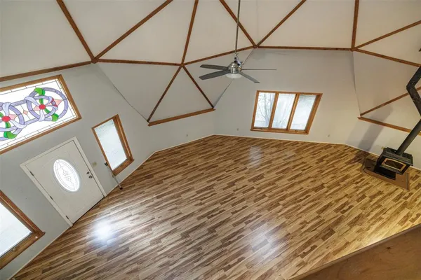 an aerial view of a houses with a yard and lake view