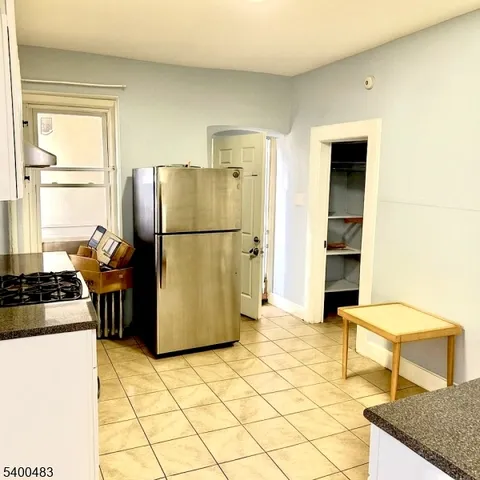 a kitchen with a refrigerator a stove a washer and dryer