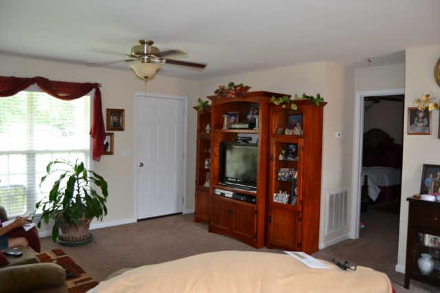 2580 Black Road Prospect, TN 38477 - Photo 6 of 7 a bedroom with a bed and a chandelier