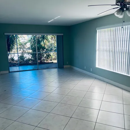 a view of a livingroom with an empty space and a ceiling fan