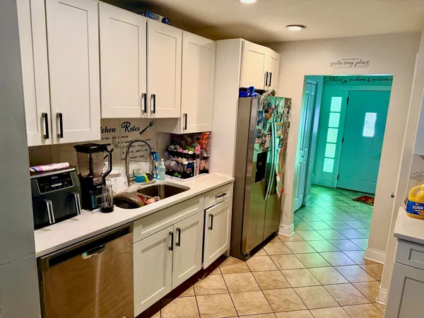 a kitchen with stainless steel appliances granite countertop a refrigerator and a stove