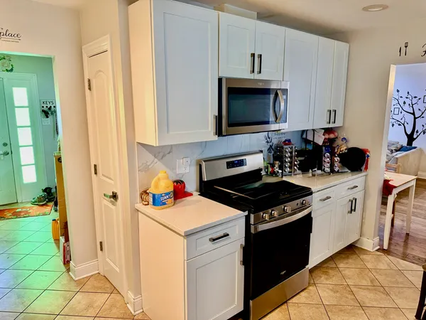 a kitchen with stainless steel appliances a white stove top oven and a refrigerator