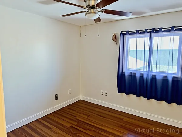 a view of a closet with wooden floor