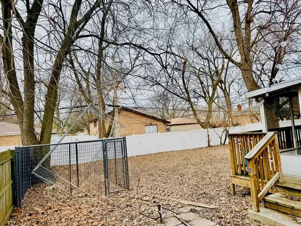 a view of a roof deck with wooden fence and floor