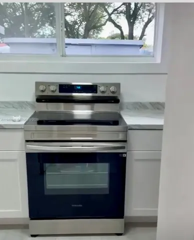 a stove top oven sitting inside of a kitchen