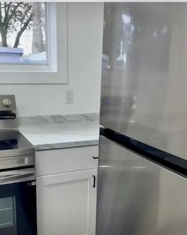 a view of storage and utility room with washer and dryer