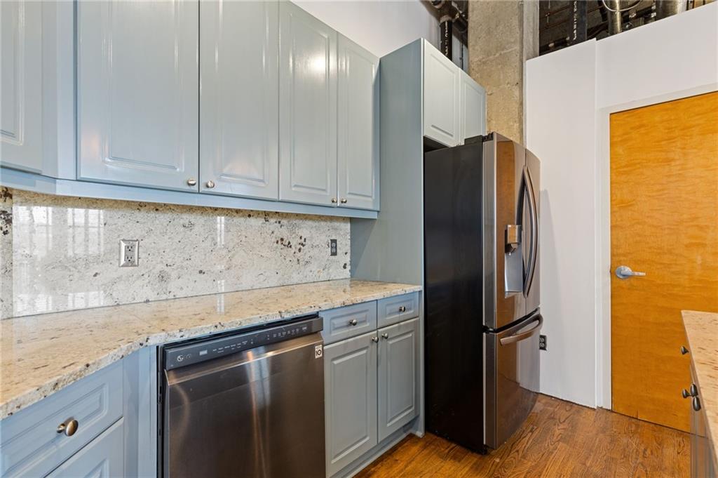 3235 Roswell Road, Unit 818 Atlanta, GA 30305 - Photo 14 of 24 a kitchen with stainless steel appliances granite countertop a refrigerator and a stove