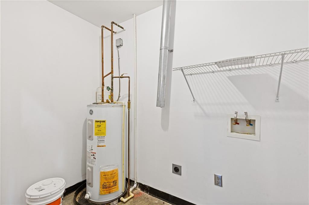 3235 Roswell Road, Unit 818 Atlanta, GA 30305 - Photo 15 of 24 a bathroom with a granite countertop sink toilet and shower