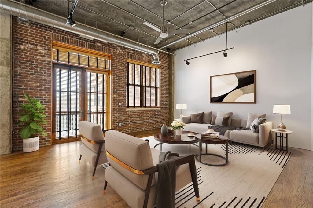 3235 Roswell Road, Unit 818 Atlanta, GA 30305 - Photo 4 of 24 a living room with furniture a wooden floor and a large window