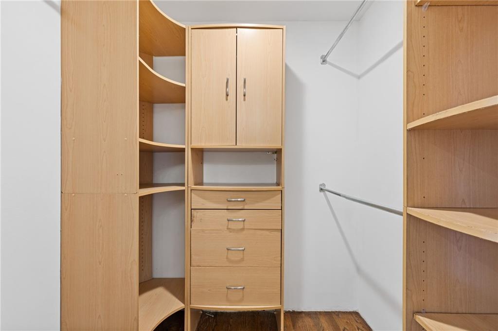 3235 Roswell Road, Unit 818 Atlanta, GA 30305 - Photo 8 of 24 a view of walk in closet with empty racks