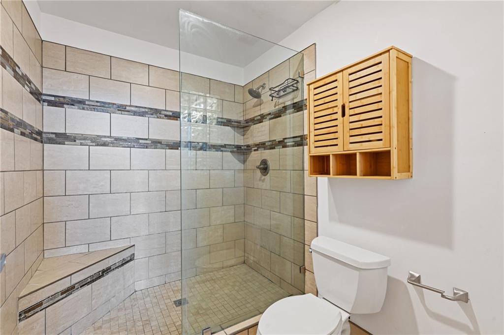 3235 Roswell Road, Unit 818 Atlanta, GA 30305 - Photo 9 of 24 a bathroom with a toilet and shower