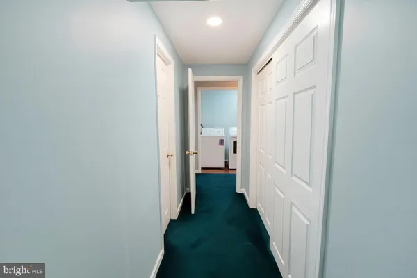 a view of a bathroom from a hallway