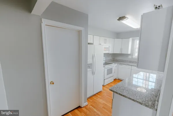 a kitchen with stainless steel appliances granite countertop a refrigerator and a stove