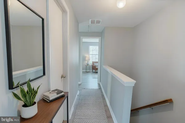 a view of hallway with wooden floor