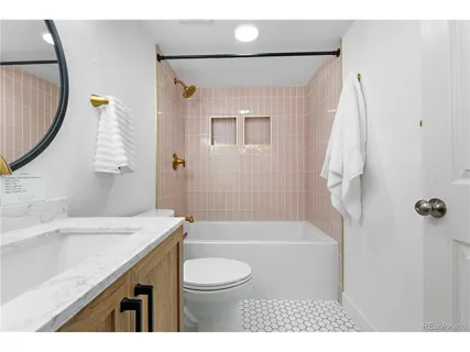 a bathroom with a sink a toilet and a mirror