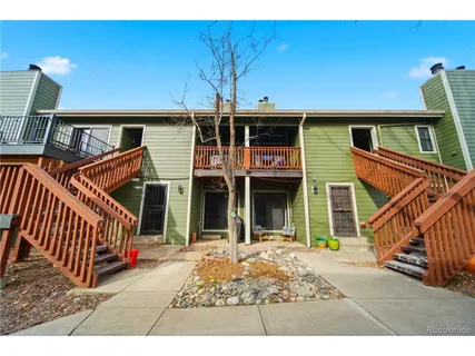 a view of a house with backyard and porch