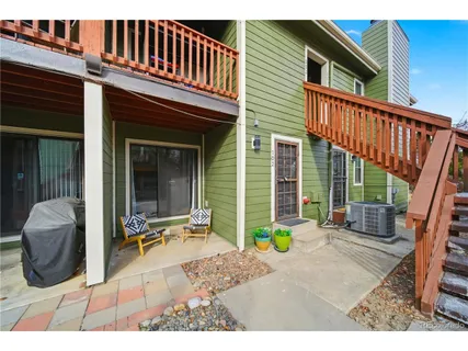 a view of a house with a patio and a yard