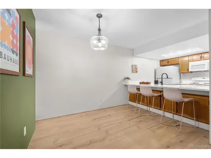 a kitchen with stainless steel appliances granite countertop a sink cabinets and wooden floor