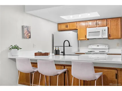 a kitchen with stainless steel appliances kitchen island granite countertop a sink and cabinets