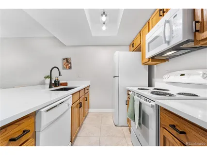 a kitchen with a sink stove and refrigerator