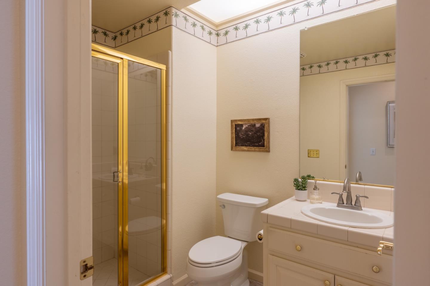 14440 Mountain Quail Road Salinas, CA 93908 - Photo 13 of 30 a bathroom with a toilet a sink and a mirror