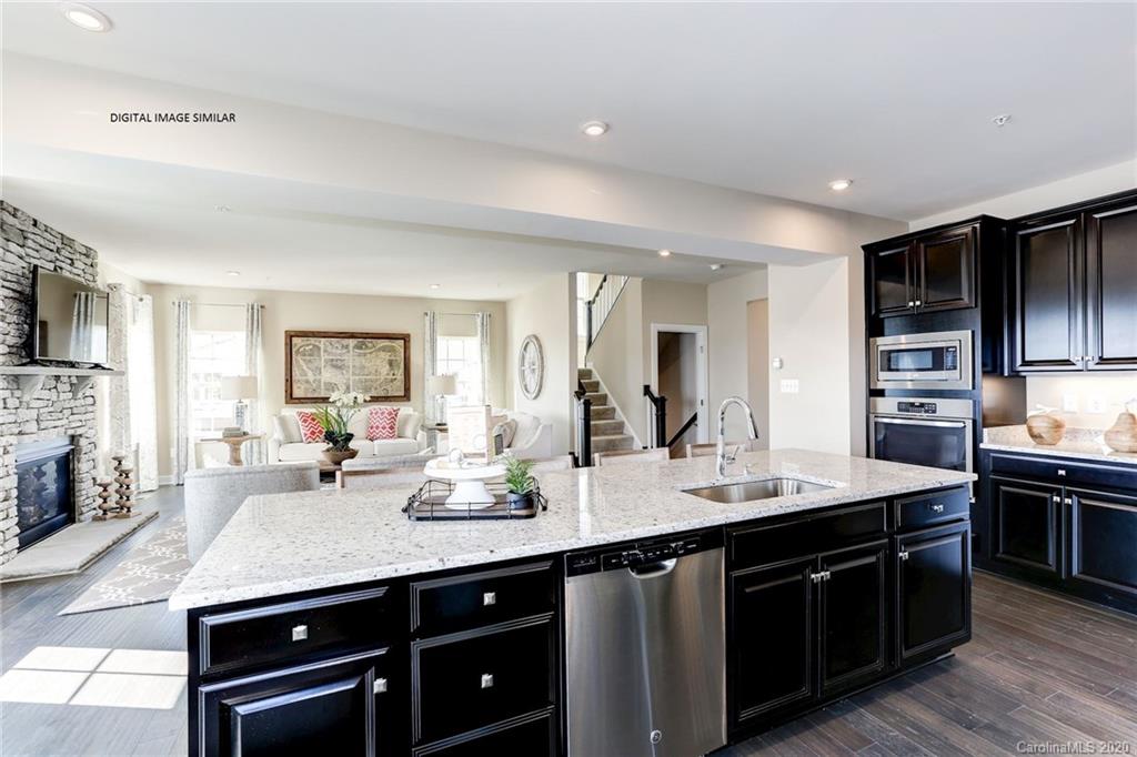 7092 Messina Road, Unit 140 Indian Land, SC 29707 - Photo 3 of 13 a kitchen with a sink appliances and cabinets