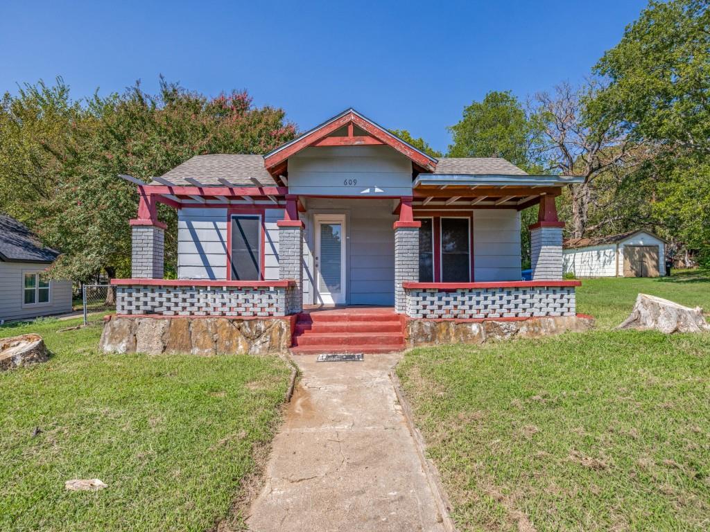 609 East Monterey Street Denison, TX 75021 - Photo 1 of 12 a front view of a house with garden