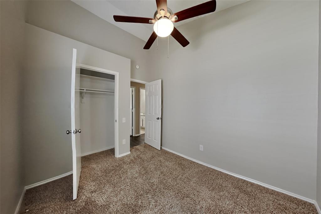 4605 Greenfern Lane Fort Worth, TX 76137 - Photo 12 of 18 an empty room with closet and a chandelier fan