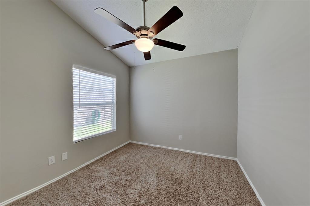 4605 Greenfern Lane Fort Worth, TX 76137 - Photo 14 of 18 an empty room with windows and fan
