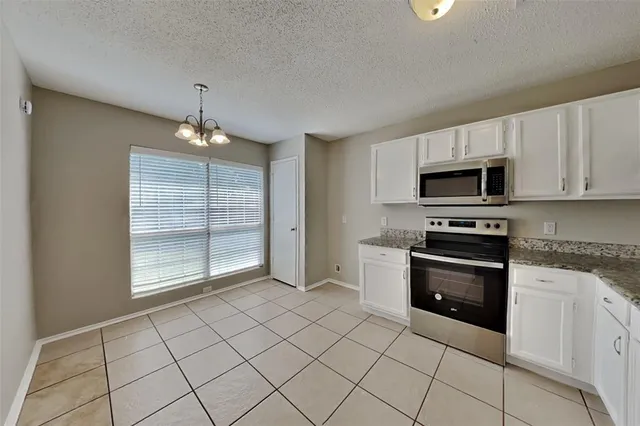 a kitchen with granite countertop a stove and a sink