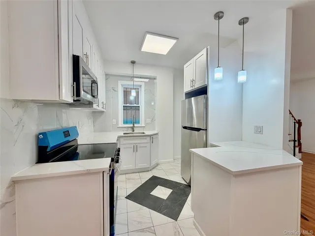 a kitchen with stainless steel appliances a refrigerator sink and stove
