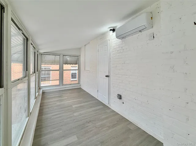 a view of a room with wooden floor and windows