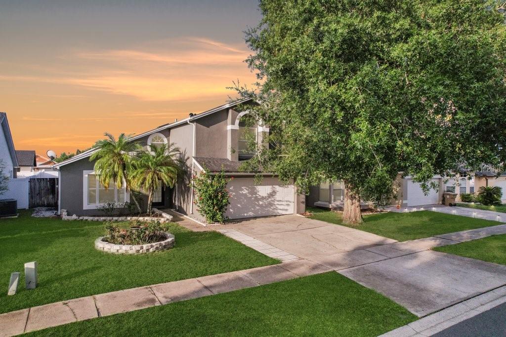 8818 Tottenham Way Kissimmee, FL 34747 - Photo 1 of 1 a front view of a house with a garden and plants